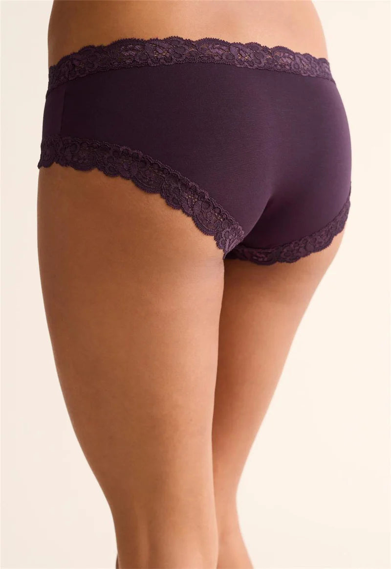 Purple lace-trimmed underwear on a beige background