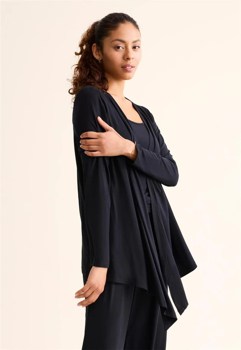 Woman wearing a black outfit against a plain background