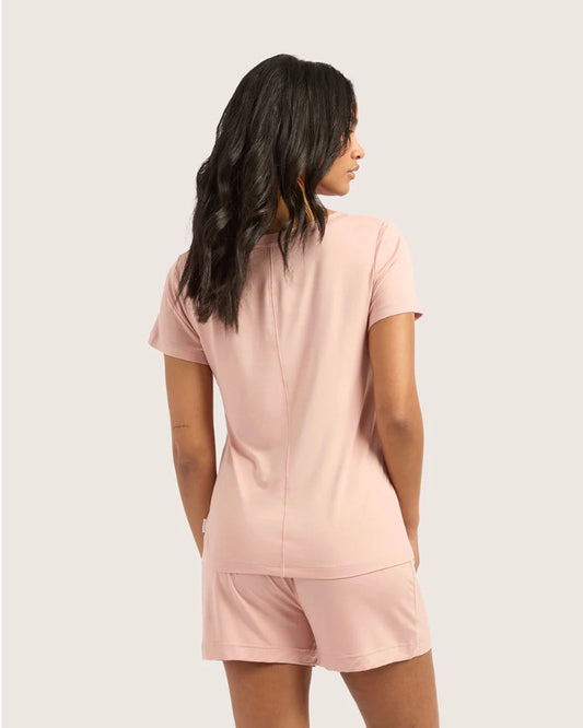 Person wearing pink pajama set with a white background