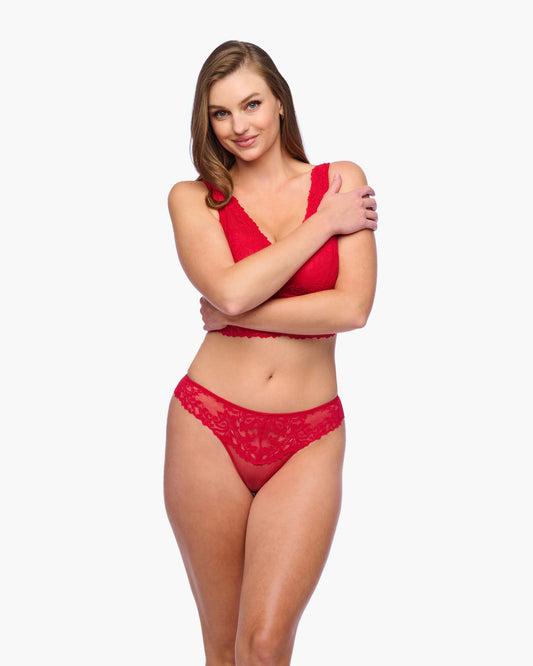 Woman wearing a red lingerie set on a white background