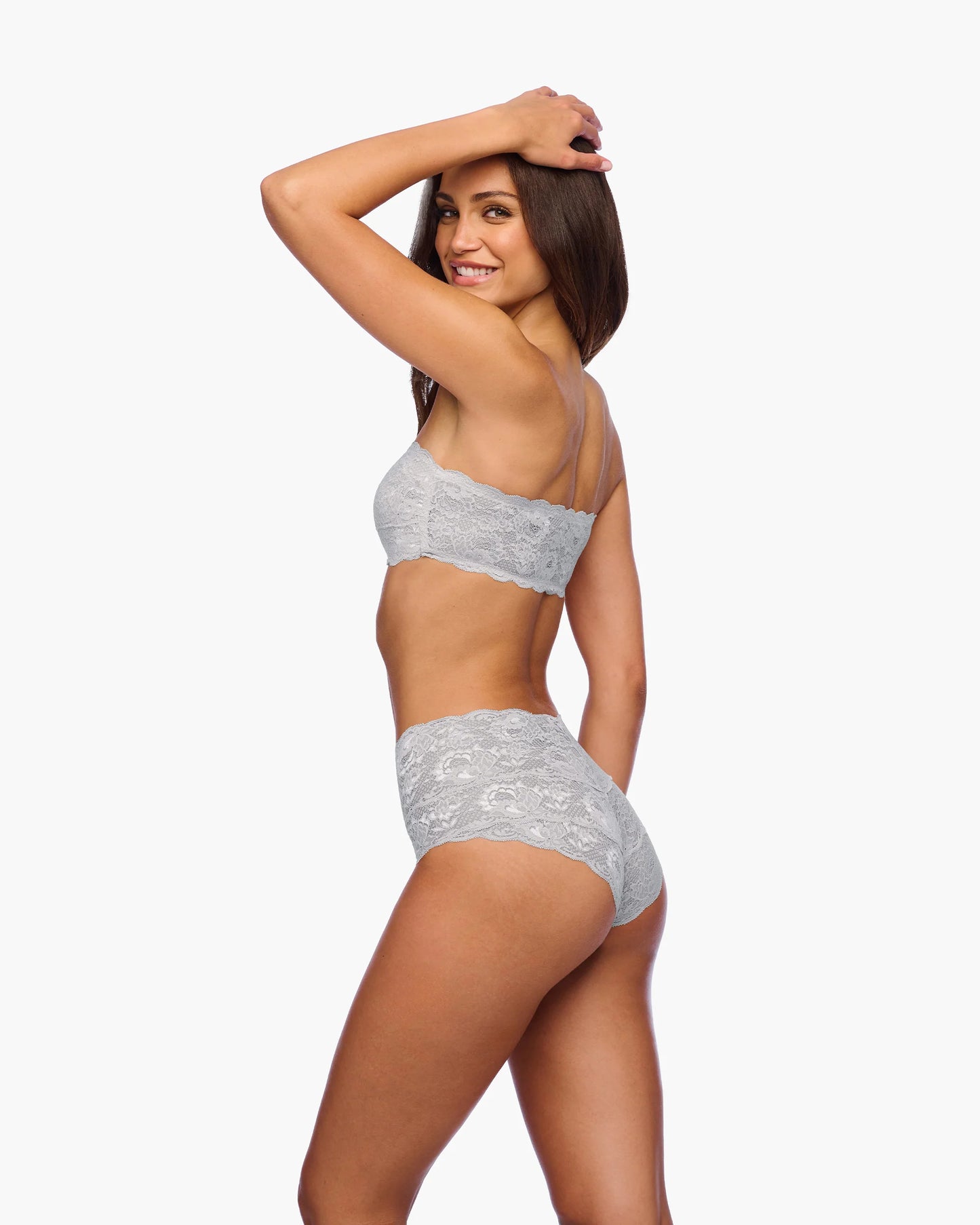 Woman wearing a gray lingerie set on a white background