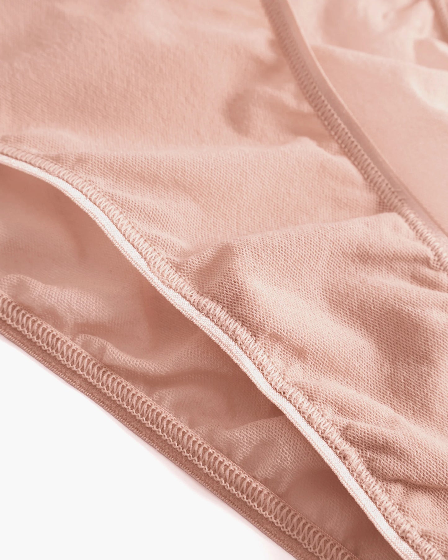 Close-up of a textured fabric with a white border on a white background