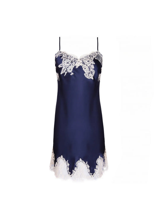 Navy blue slip dress with white lace details on a white background