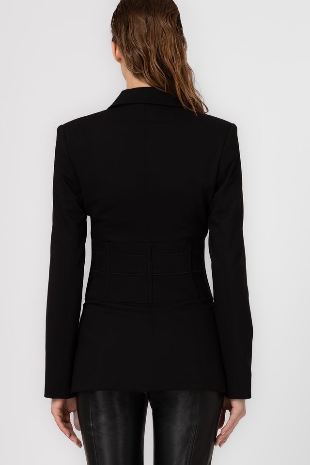 Black blazer worn by a person on a white background