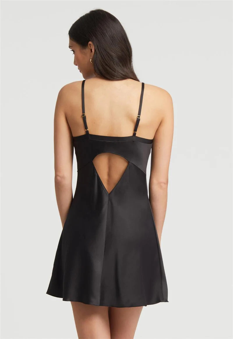 Black satin slip dress with cut-out design on a plain background