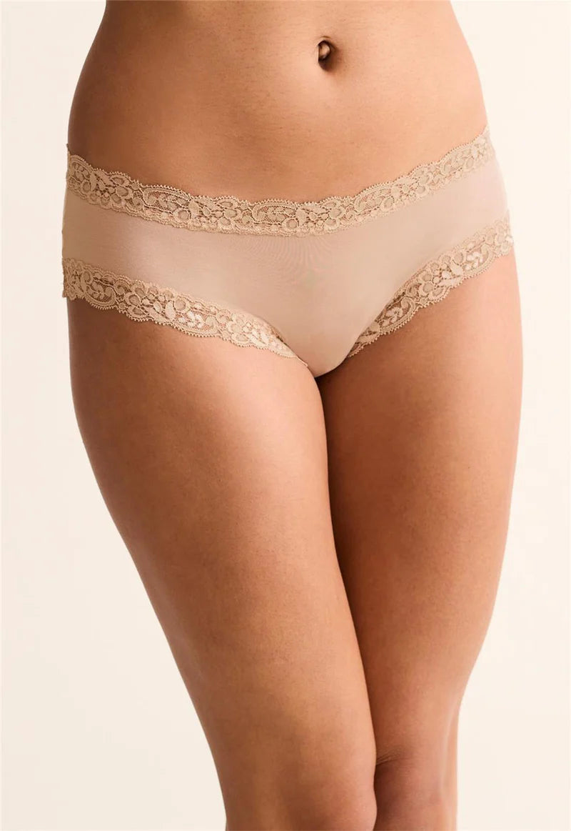 Beige lace underwear on a plain background