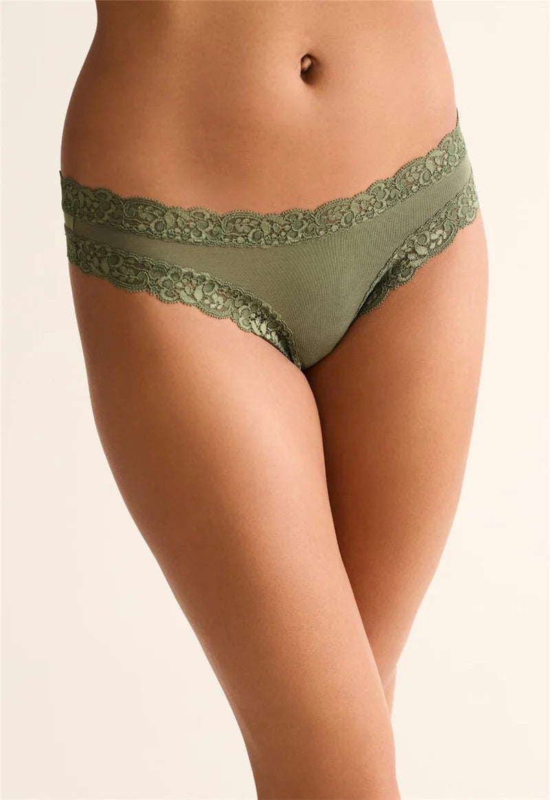 Green lace underwear on a beige background