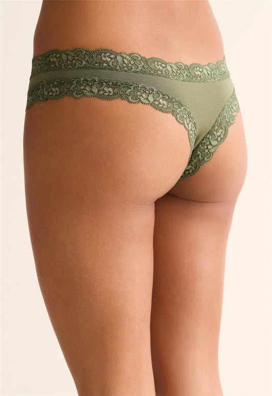 Green lace underwear on a beige background