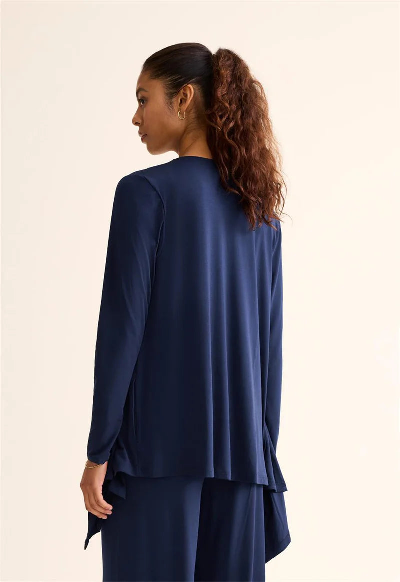 Woman wearing a blue outfit with a plain background