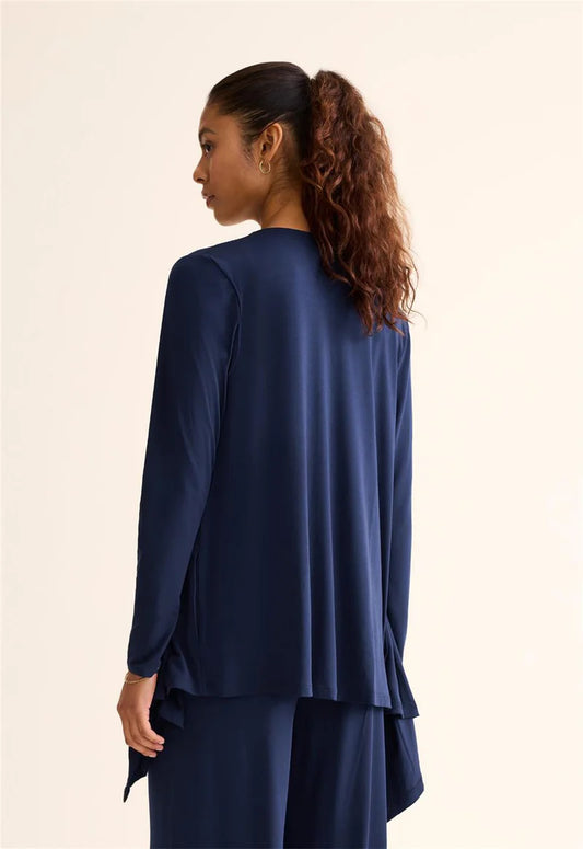 Woman wearing a blue outfit with a plain background