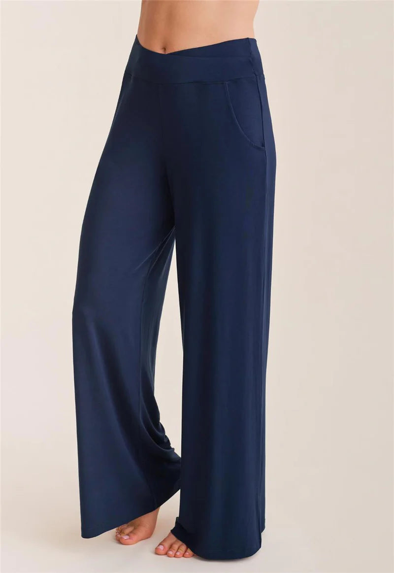 Navy blue wide-leg pants worn by a person on a beige background