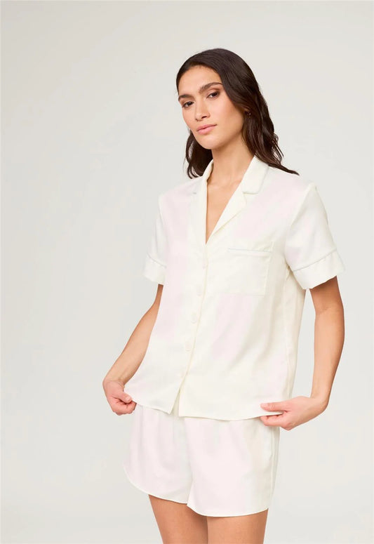 Woman wearing a white outfit on a plain background