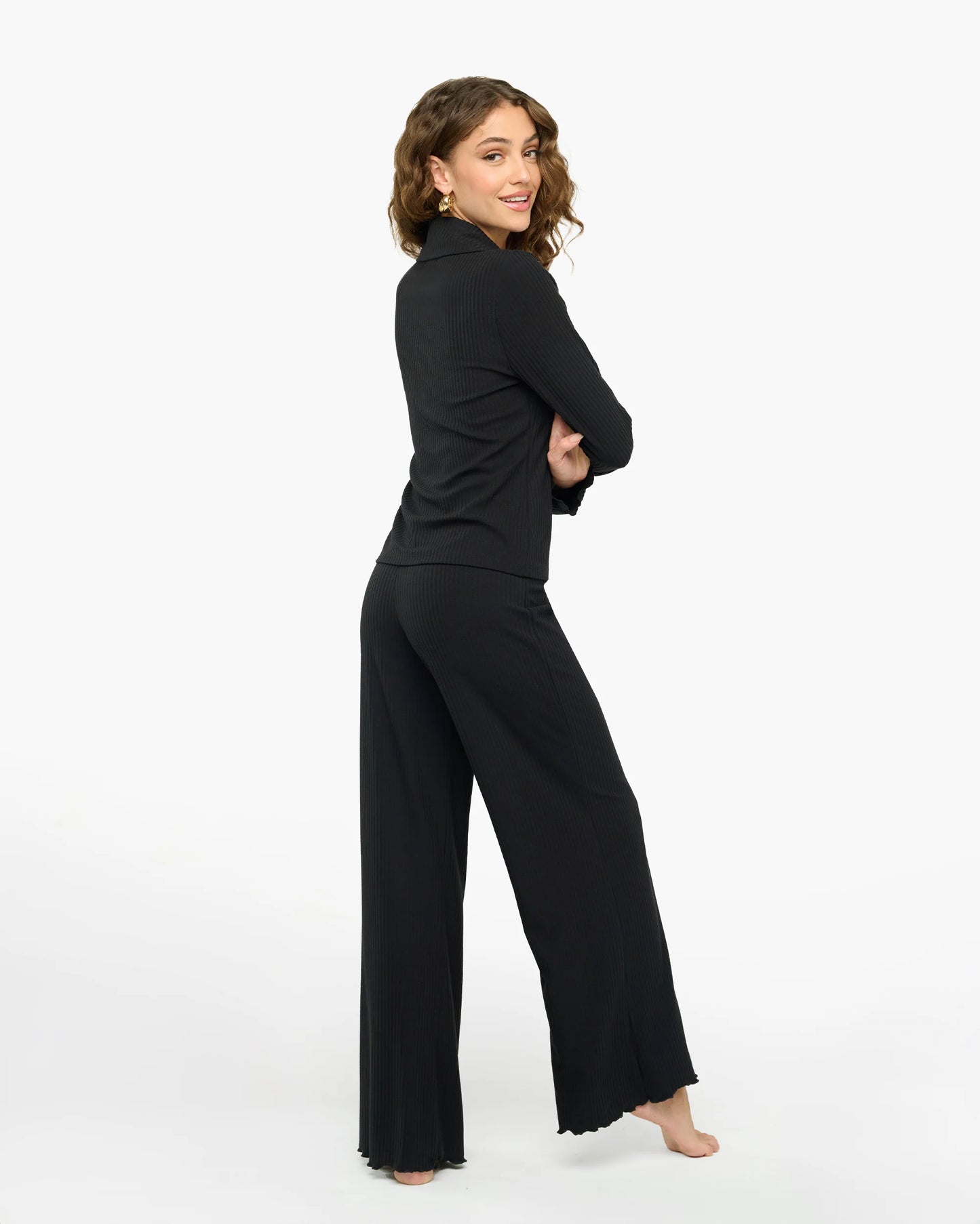 Woman wearing a black outfit on a white background