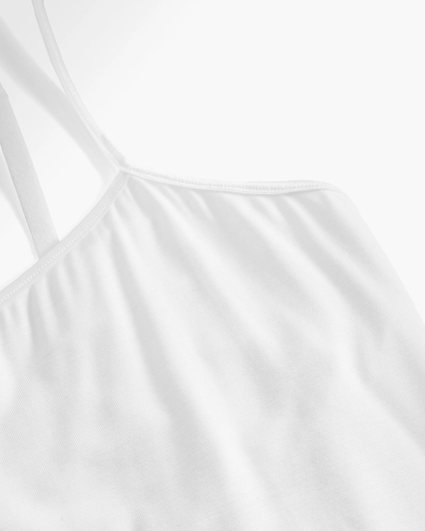 Close-up of a white tank top with thin straps 