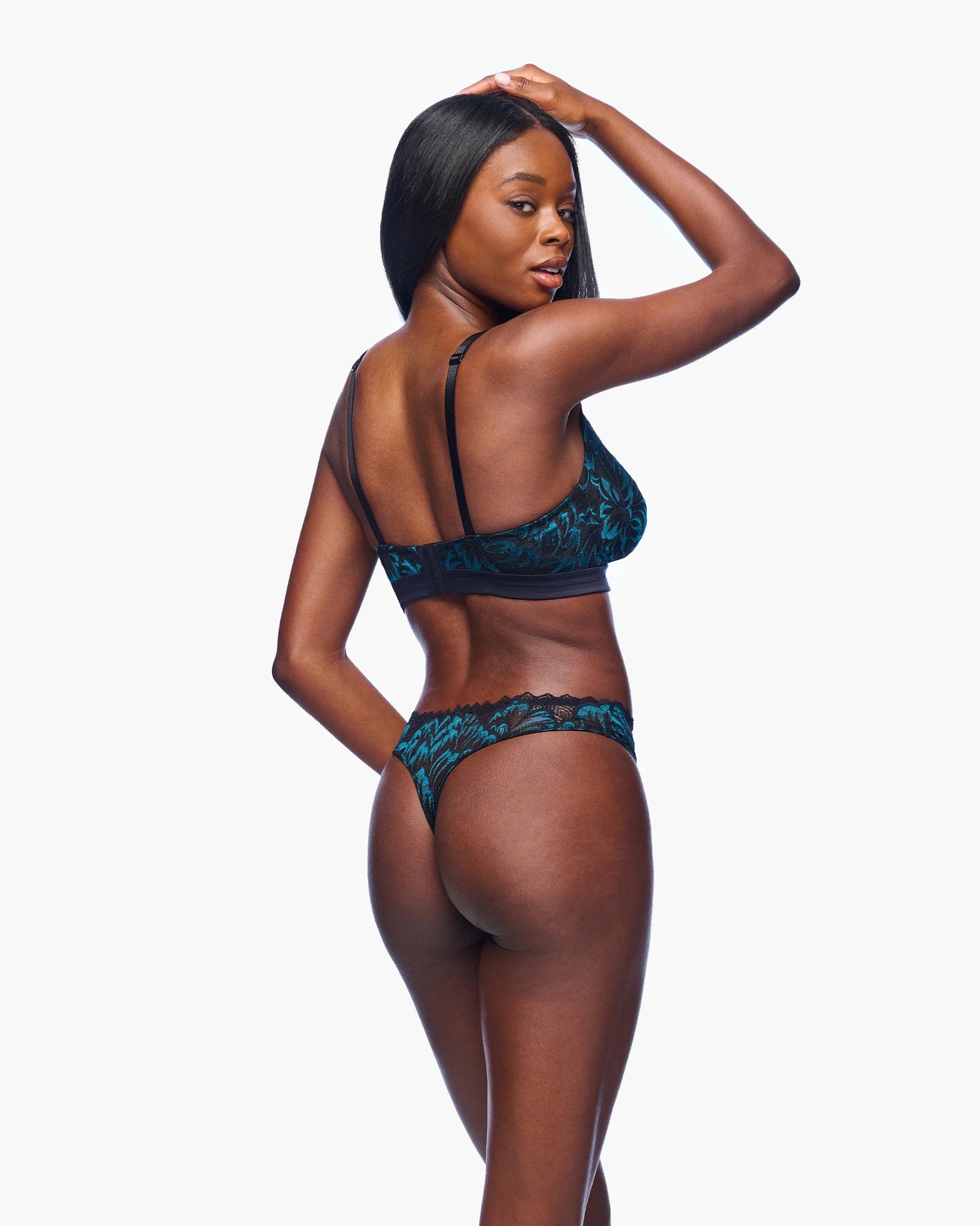 Woman wearing a blue lingerie set on a white background