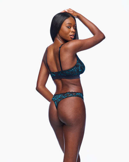 Woman wearing a blue lingerie set on a white background