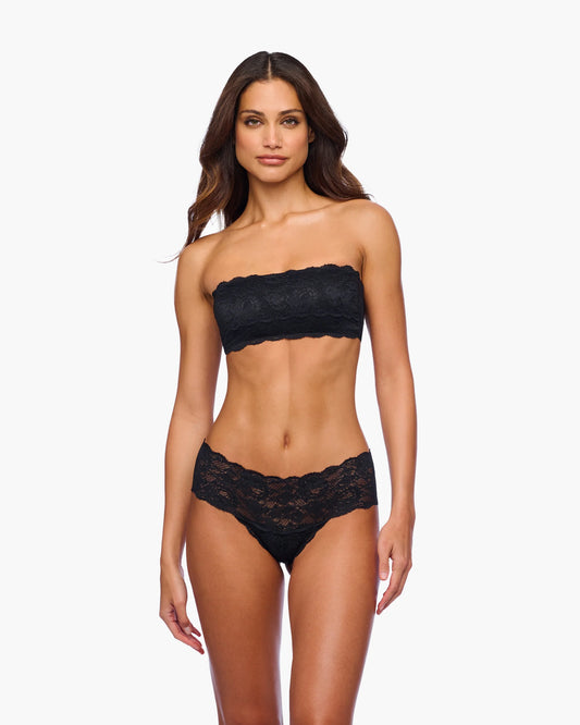 Woman wearing a black lace lingerie set on a white background