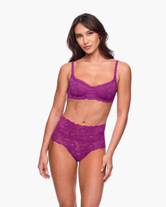 Woman wearing a purple lingerie set on a white background
