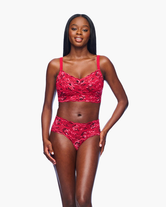 Woman wearing a red lace lingerie set on a white background
