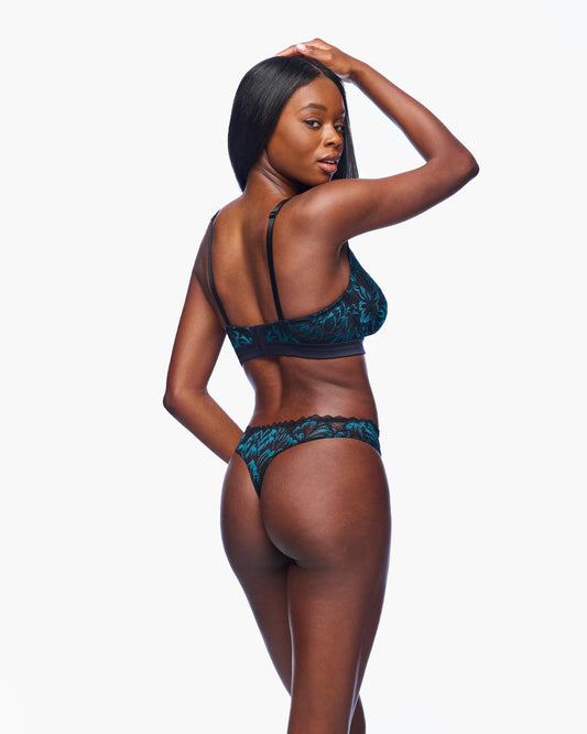 Woman wearing a blue lingerie set on a white background