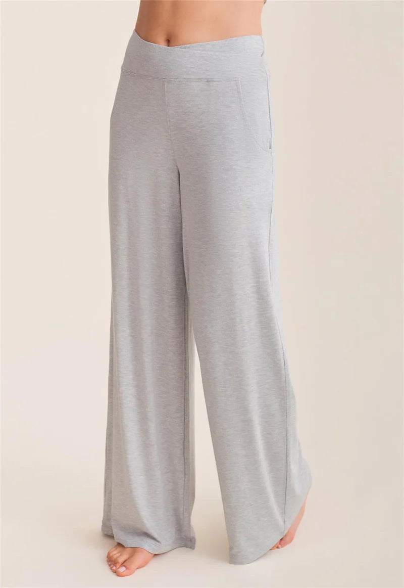 Light gray wide-leg pants worn by a person on a beige background