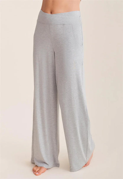 Light gray wide-leg pants worn by a person on a beige background