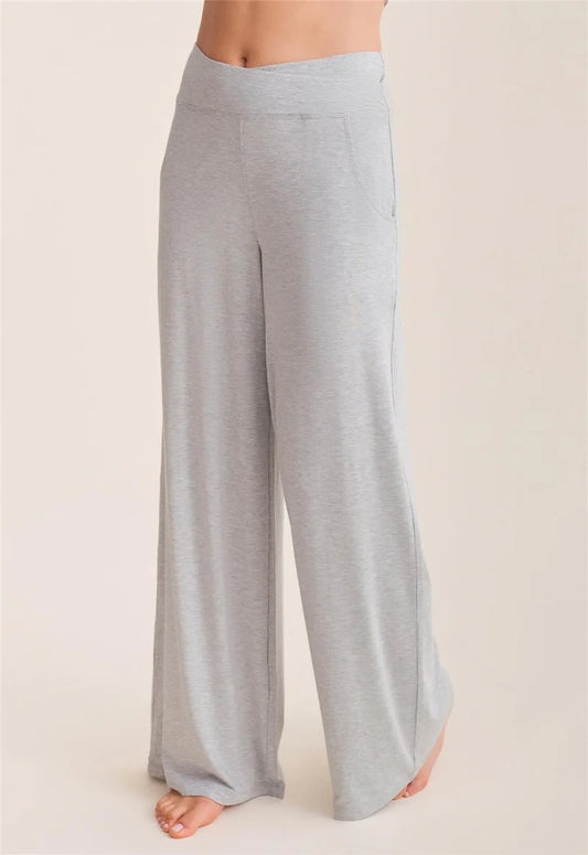 Light gray wide-leg pants worn by a person on a beige background