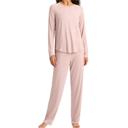 Pink pajama set worn by a person on a white background