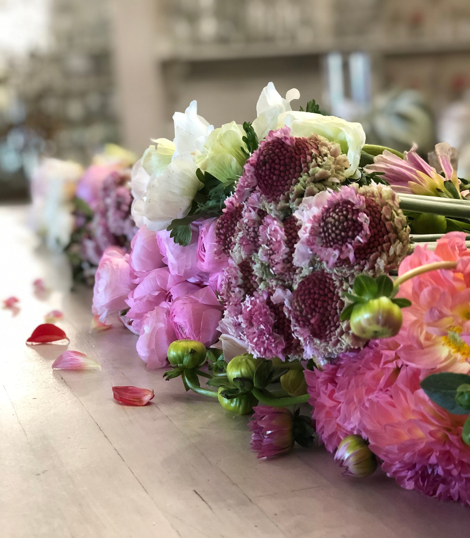 Bouquets of pink and purple flowers on a wooden floor