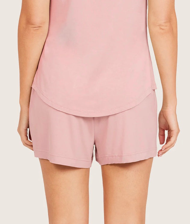 Person wearing a pink layered outfit on a plain background