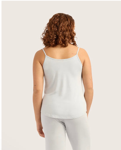 Person wearing a light gray tank top and pants on a white background