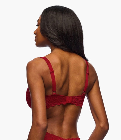 Red lace bra worn by a model on a white background