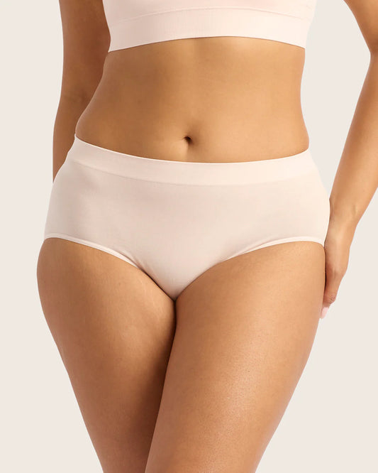 Beige underwear worn by a person on a light gray background