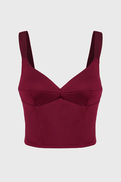Maroon corset top with thin straps on a light gray background