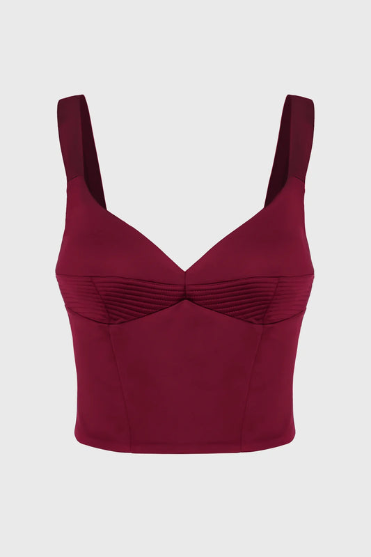 Maroon corset top with thin straps on a light gray background