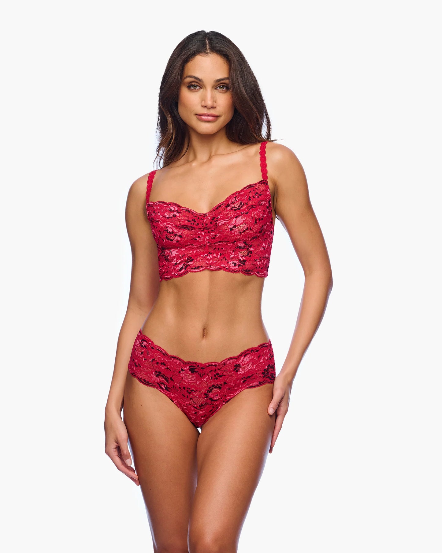Woman wearing a red lace lingerie set on a white background