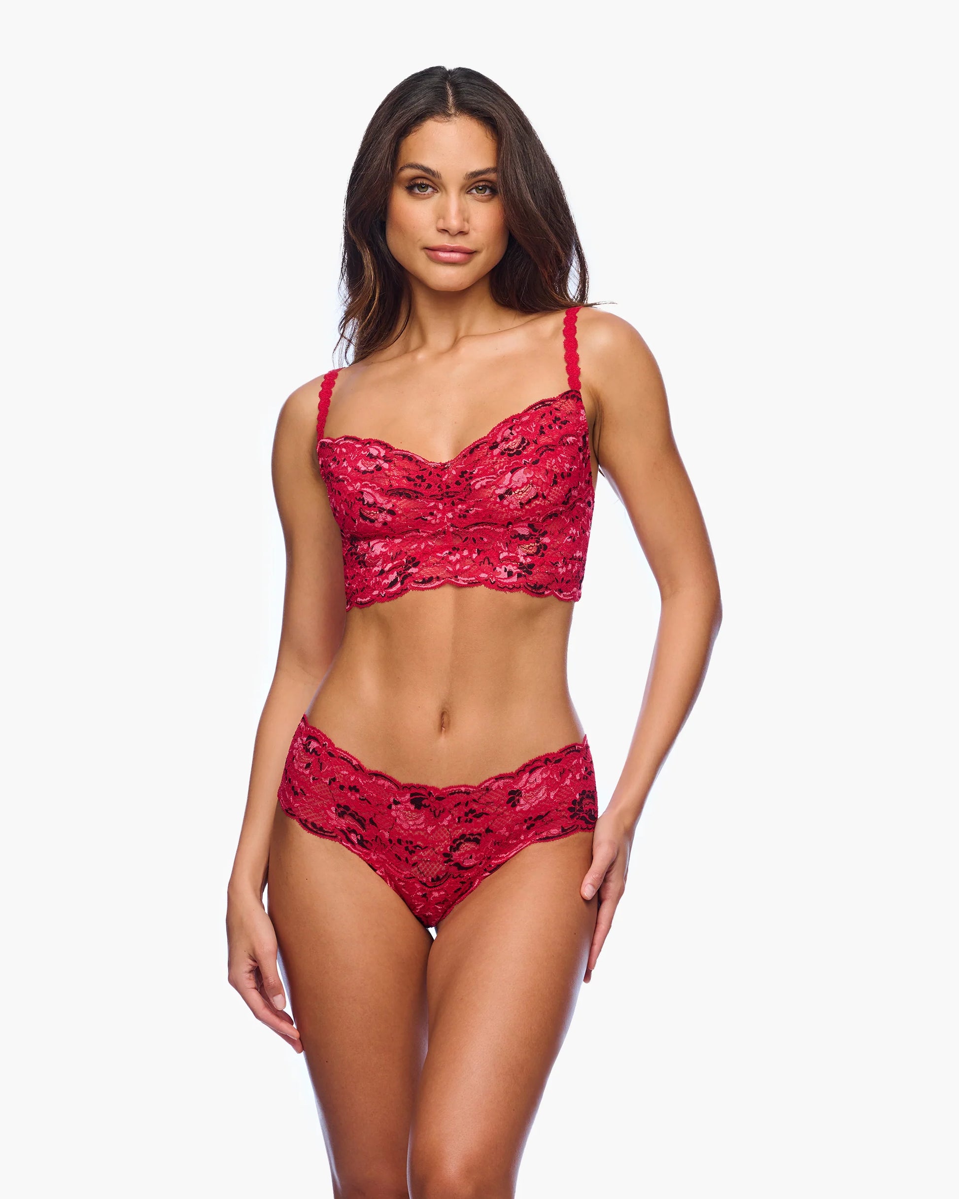 Woman wearing a red lace lingerie set on a white background