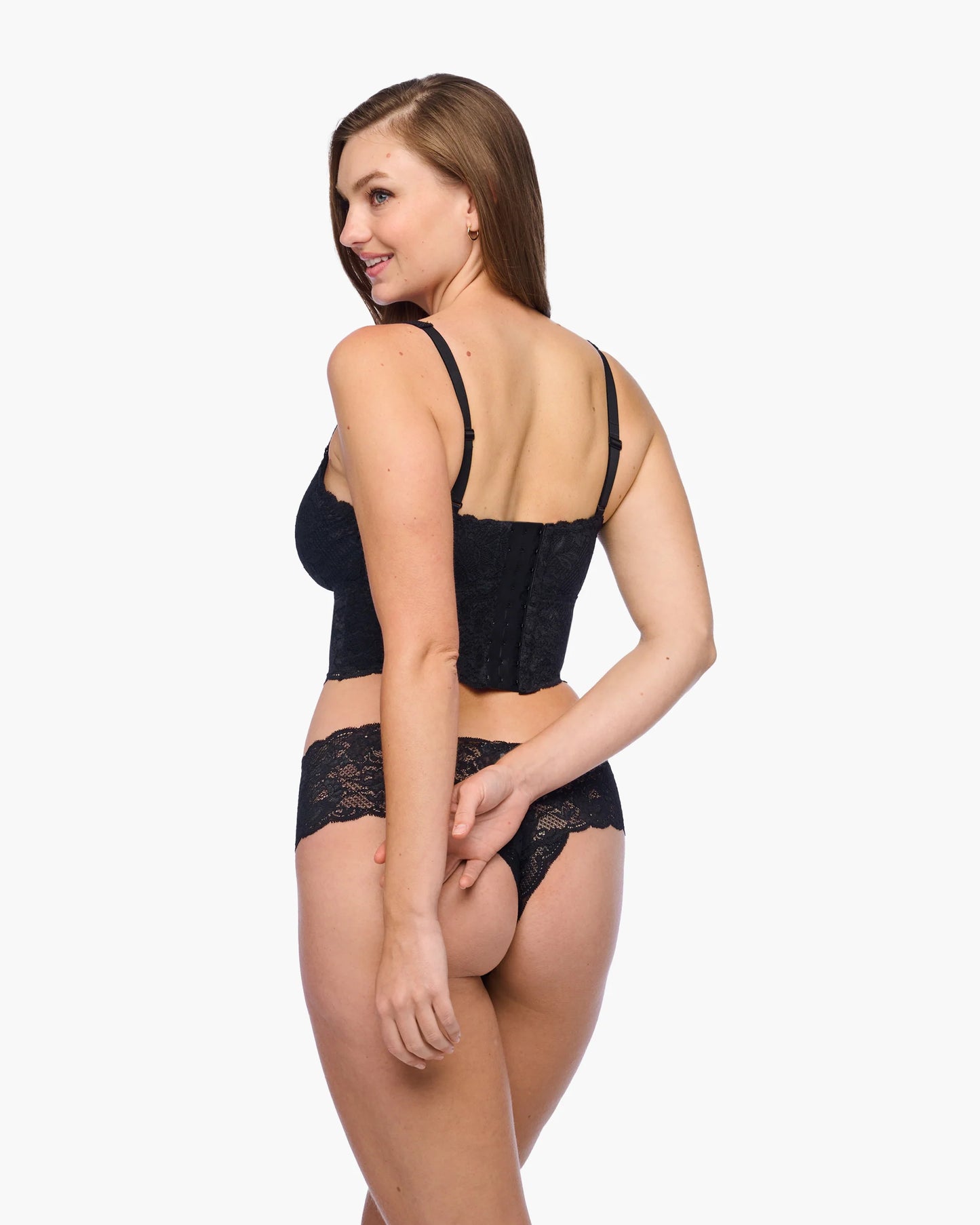 Woman wearing black lace lingerie on a white background