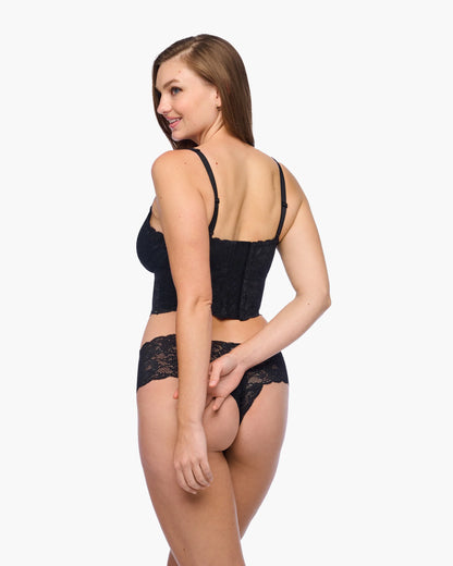 Woman wearing black lace lingerie on a white background