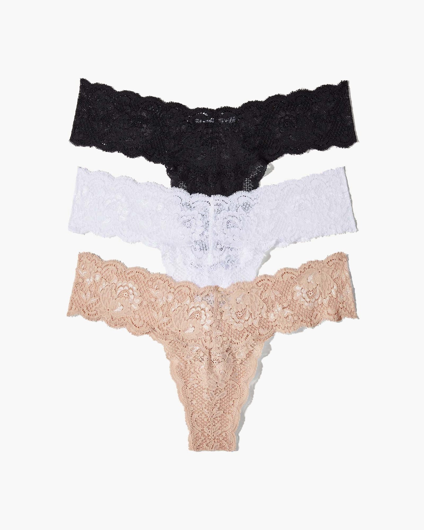 Three lace-trimmed panties in black, white, and beige on a white background