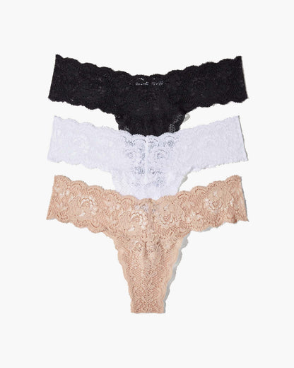 Three lace-trimmed panties in black, white, and beige on a white background