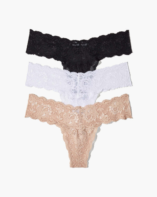Three lace-trimmed panties in black, white, and beige on a white background