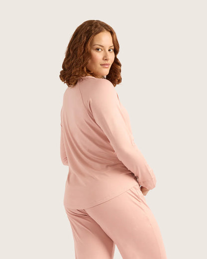 Woman wearing a pink outfit on a light beige background