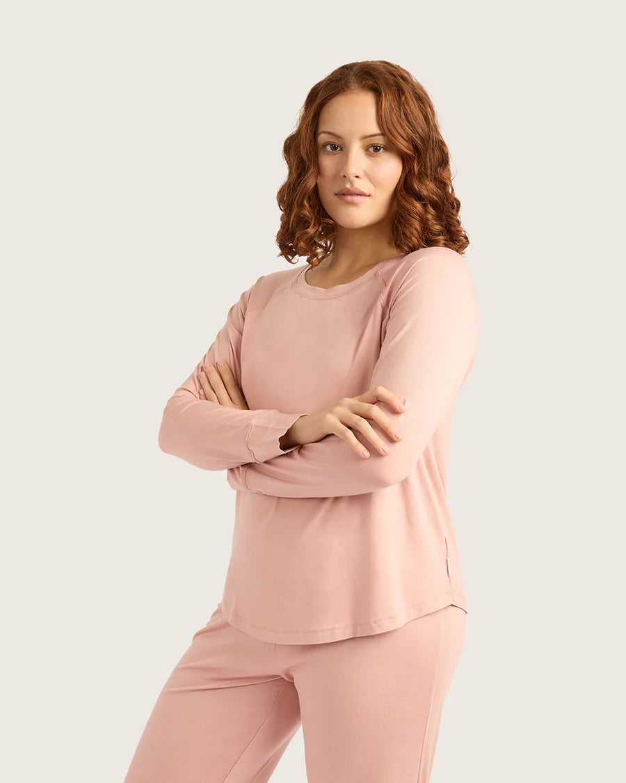 Woman wearing a pink outfit on a light beige background
