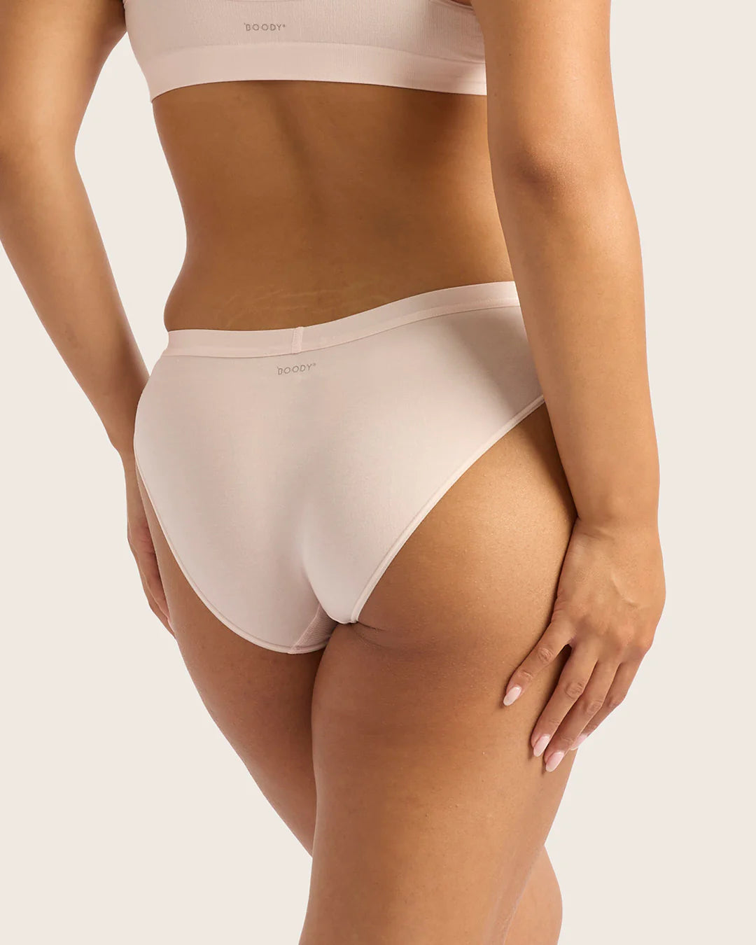 Person wearing white underwear on a plain background