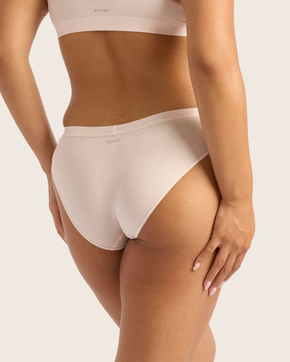 Person wearing white underwear on a plain background