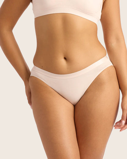 Beige bikini worn by a person on a plain background