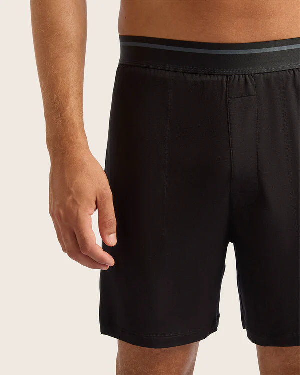 Black shorts with a black waistband on a neutral background