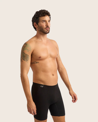Man wearing black underwear on a plain background