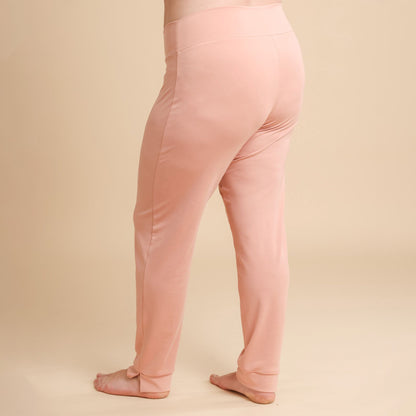 Pink leggings worn by a person on a beige background